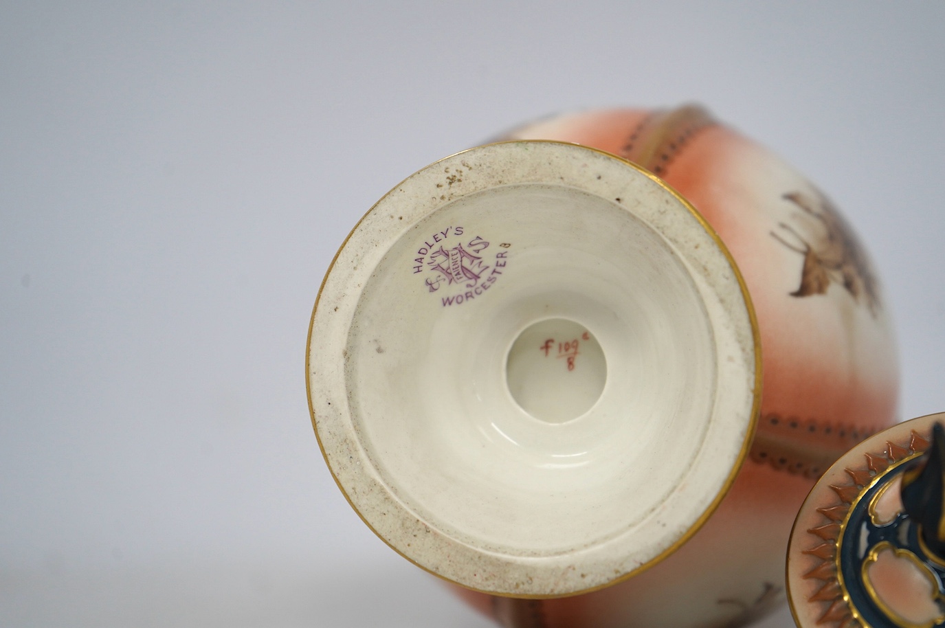 A Hadleys Worcester faience vase and cover, 31cm high. Condition - fair, the pommel on the lid has been broken and reattached